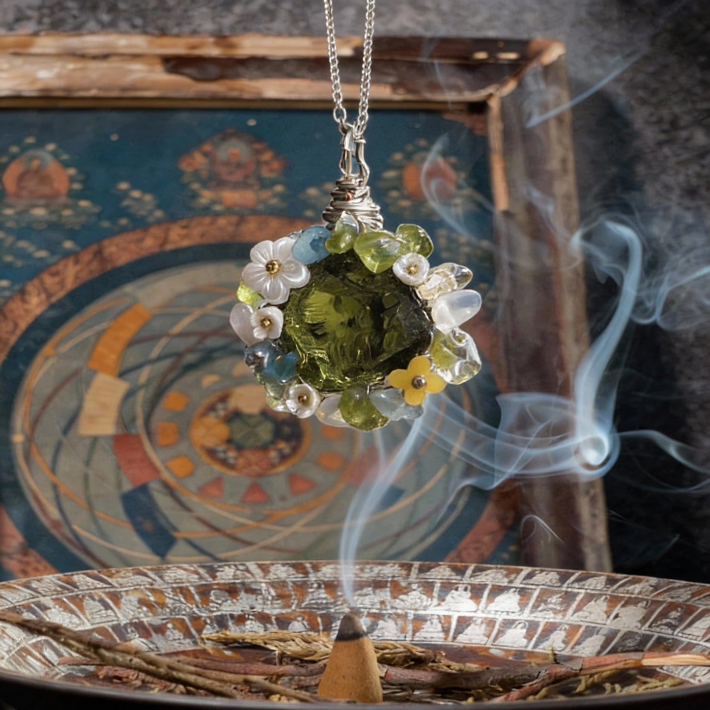 Pendant suspended above an incense burner with decorative backdrop and smoke.